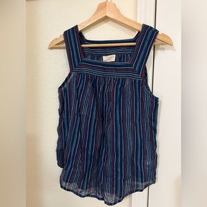 Sleeveless blue top with strips